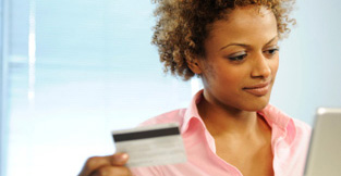 Young woman with her credit card going online to review her spending habits.
