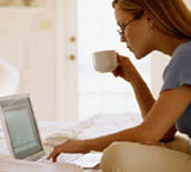 Image of a young woman in front of her laptop