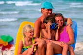 Image of family sitting on the beach